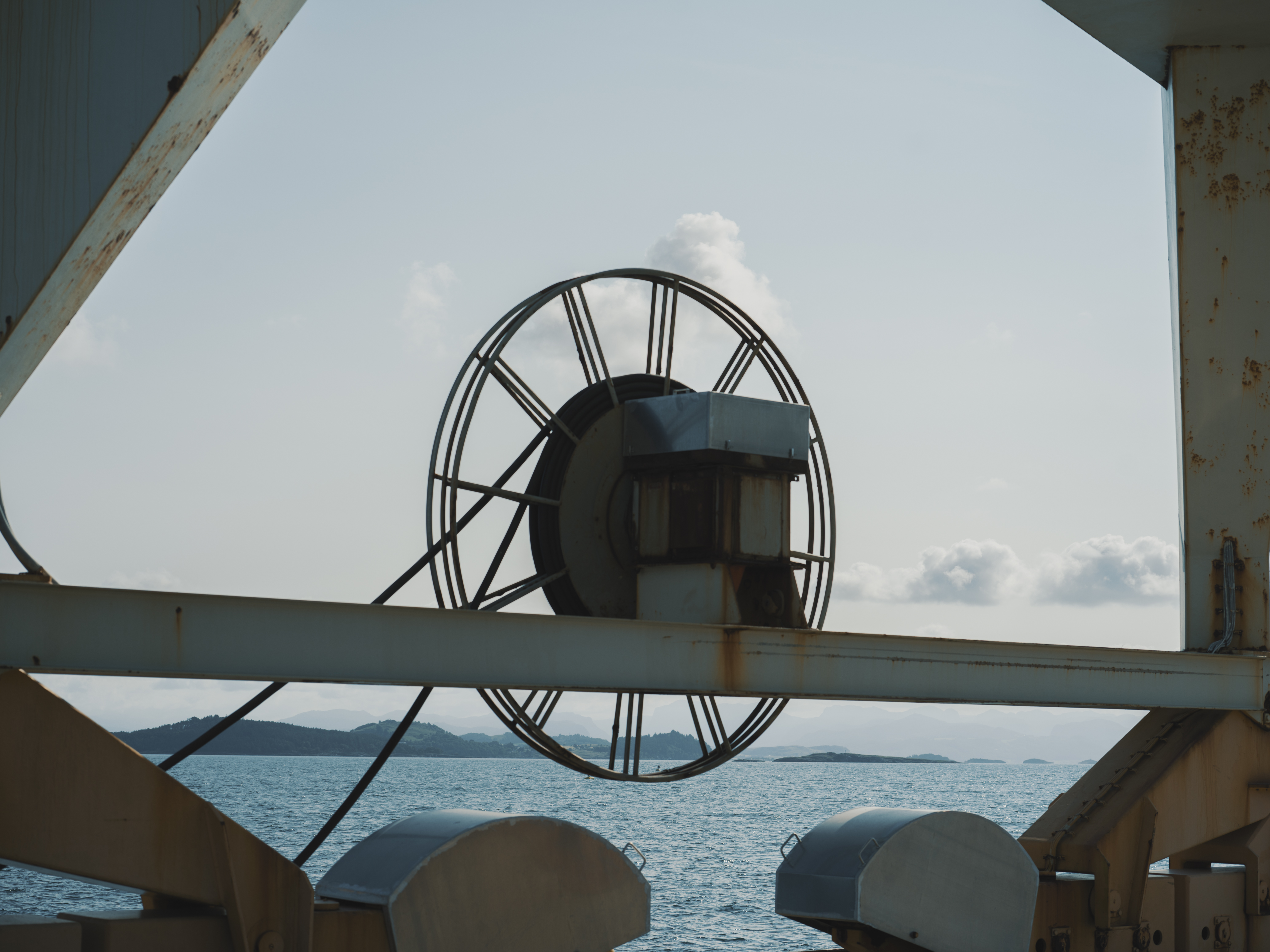 Person working on an oil rig looking at a tablet